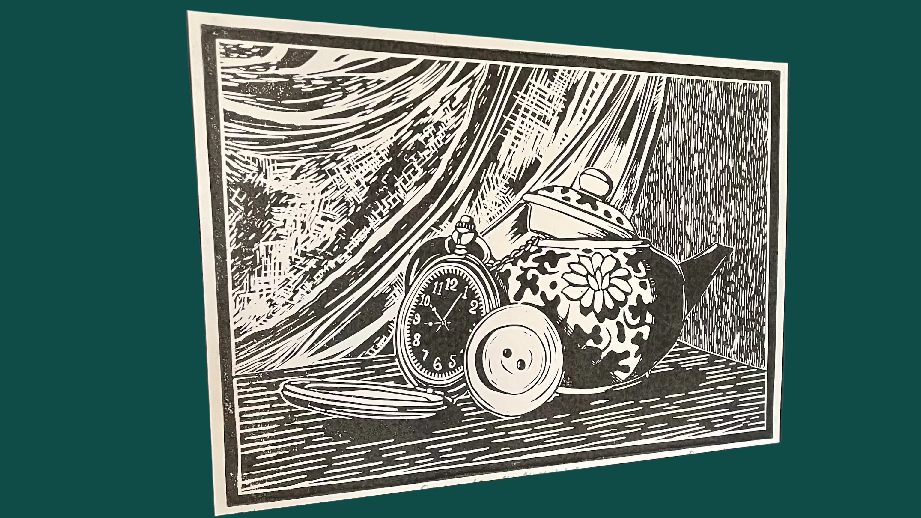 Black and white Linocut print artwork of a teapot, button and pocket watch displayed on a wooden surface.